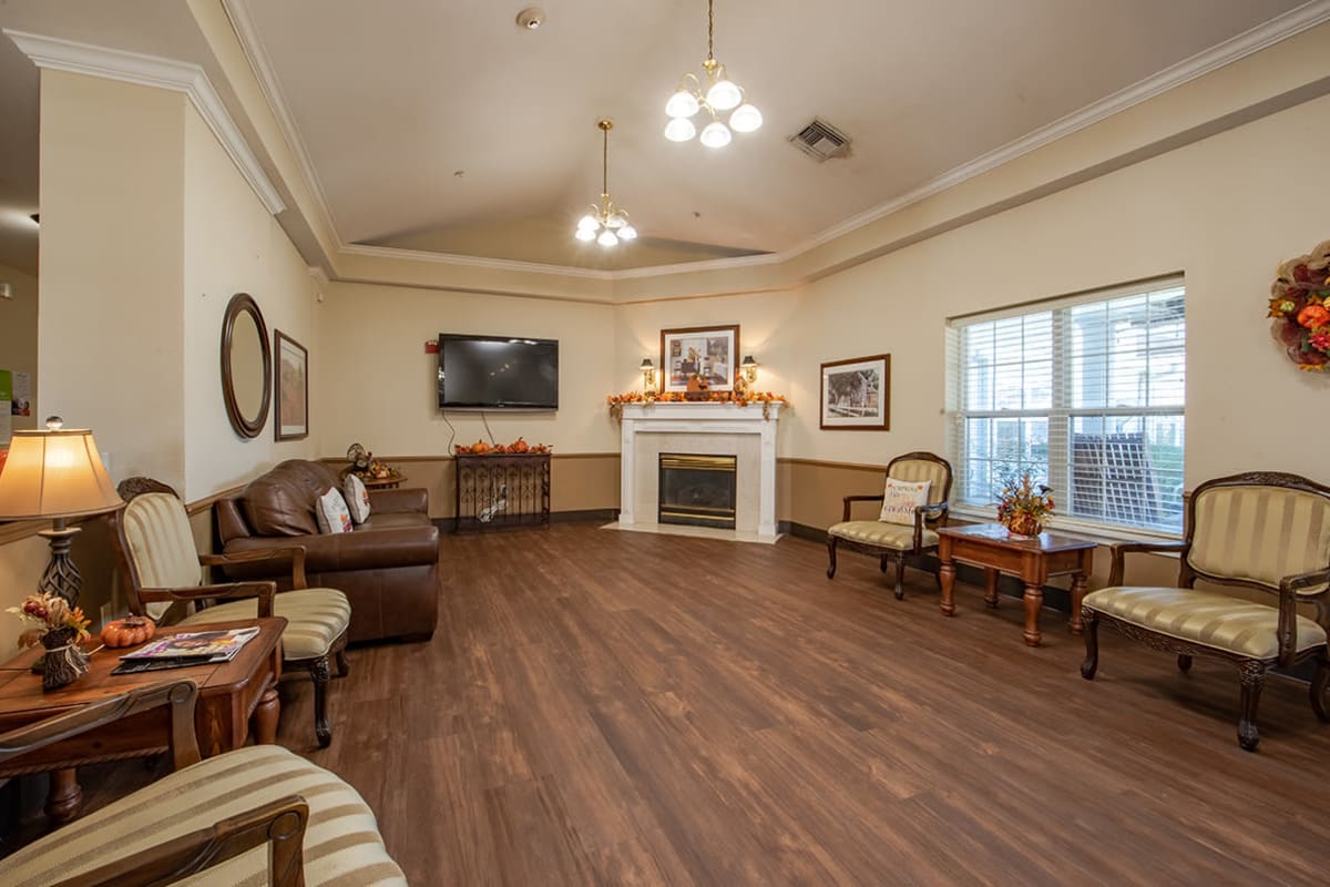 den and media room with comfortable seating and fireplace at Trustwell Living at Bailey Place in Bunkie, Louisiana