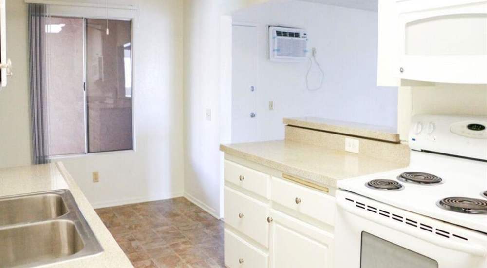 Kitchen with white appliances at Casa Madrid in Cypress, California