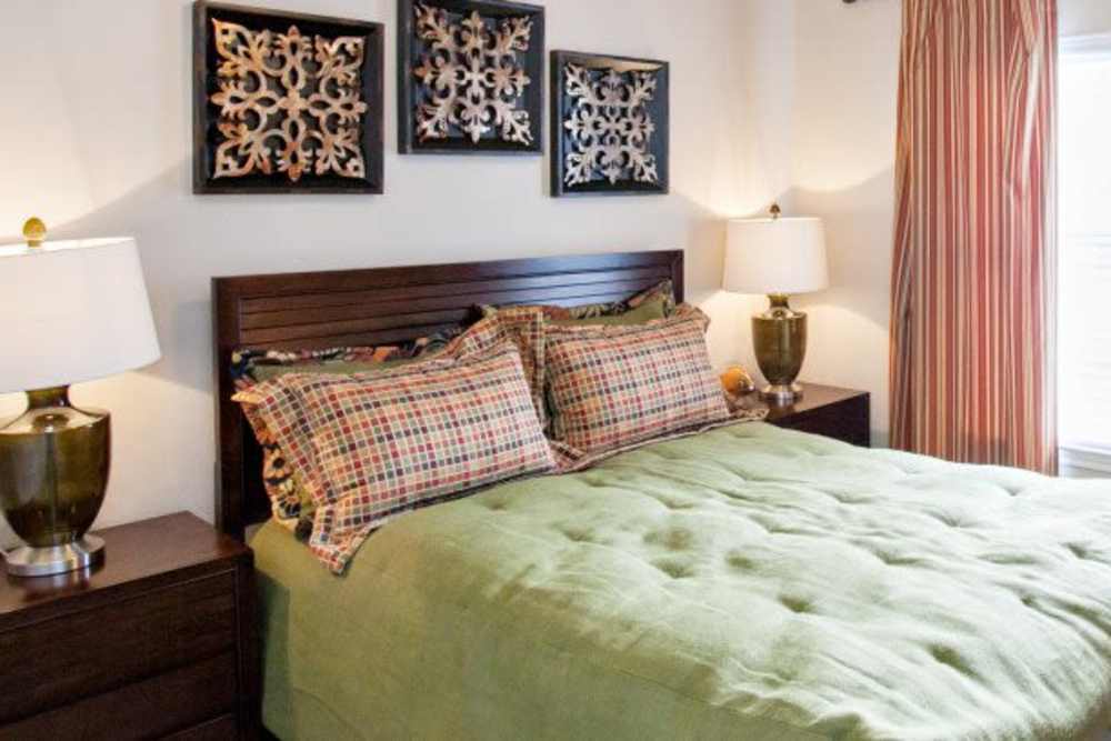 Well-lit spacious bedroom with lamp at Madison at Dell Ranch in Round Rock, Texas