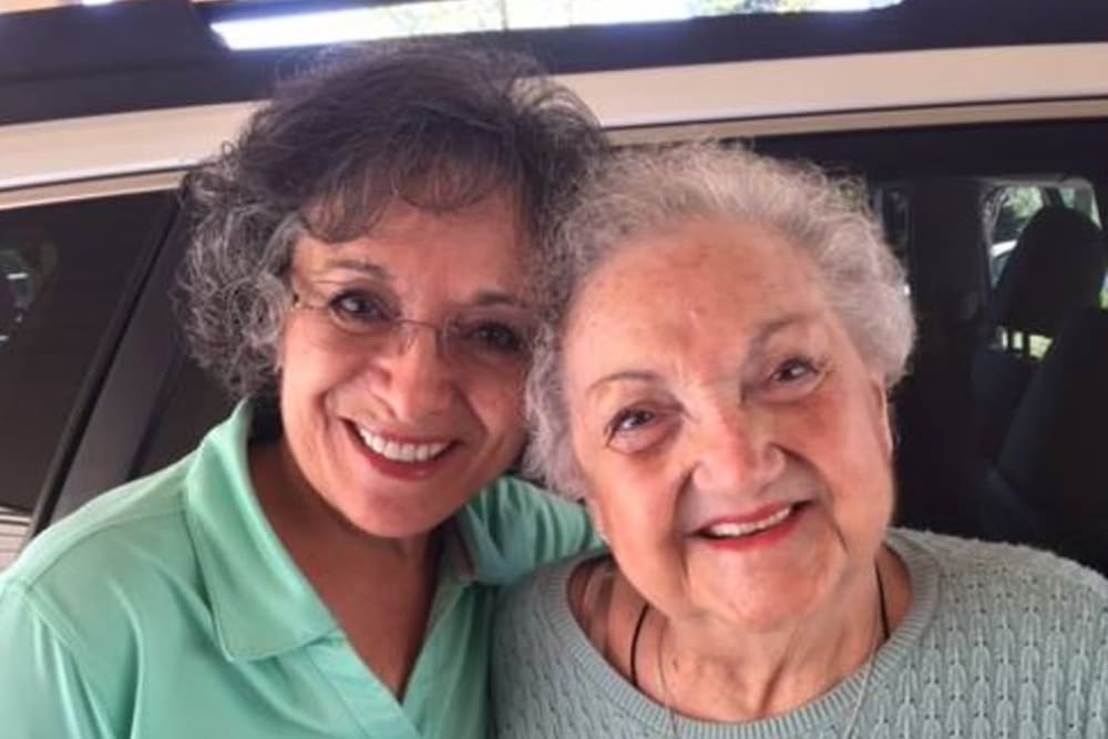 Residents smiling for a lovely photo together at Hilltop Commons Senior Living in Grass Valley, California