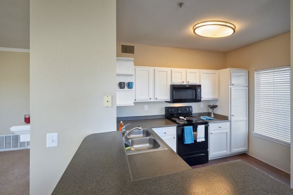 White Kitchen Cabinetry at Skyecrest Apartments in Lakewood, CO