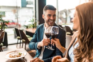 Residents drinking a glass of wine near Wythe Apartment Homes in Irving, Texas