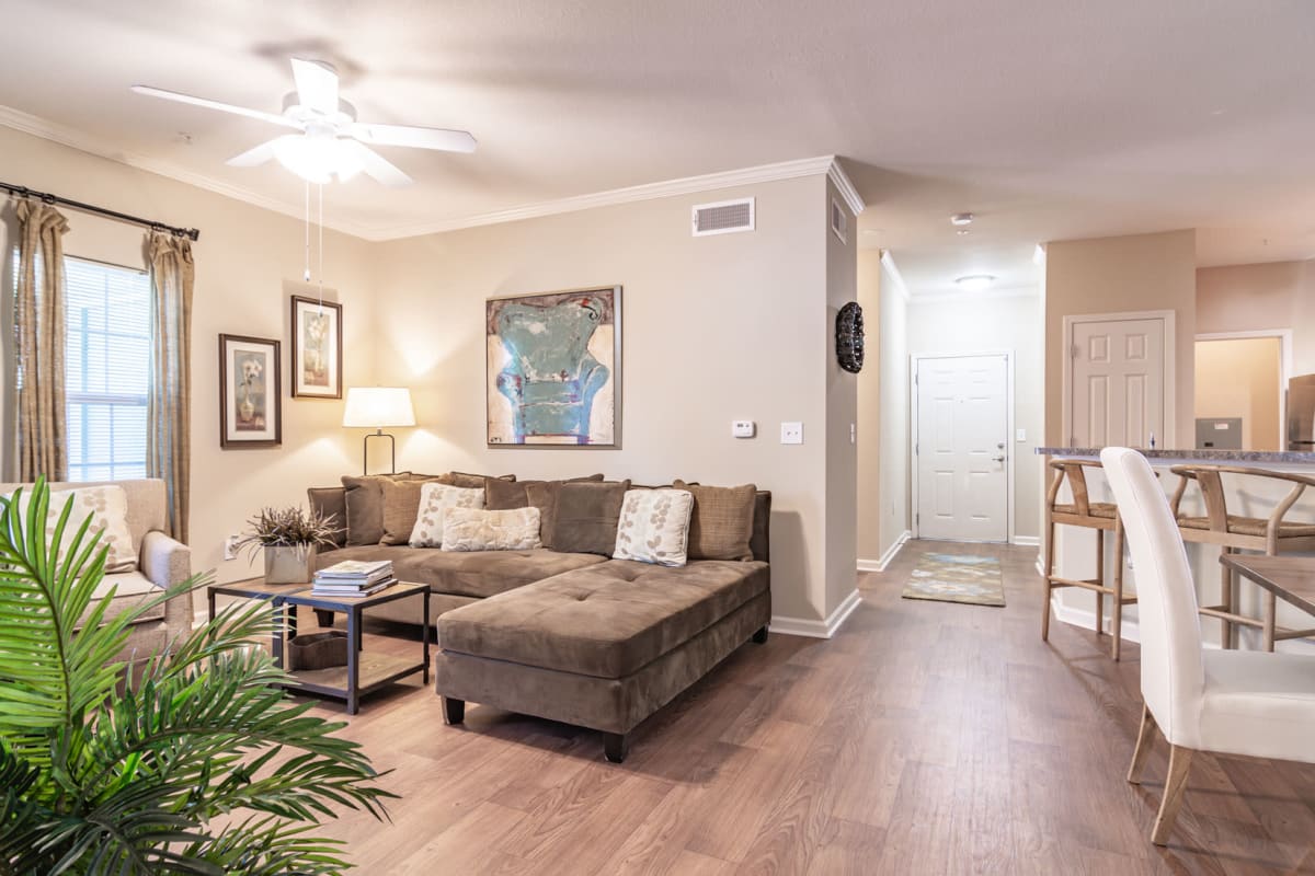 Living room with wood-style flooring at Crossings of Opelika in Opelika, Alabama