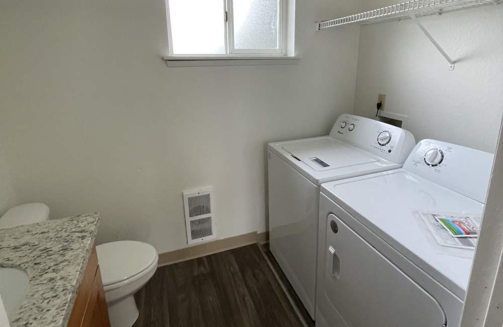 Bathroom with washer and dryer at Cherry Creek Apartments