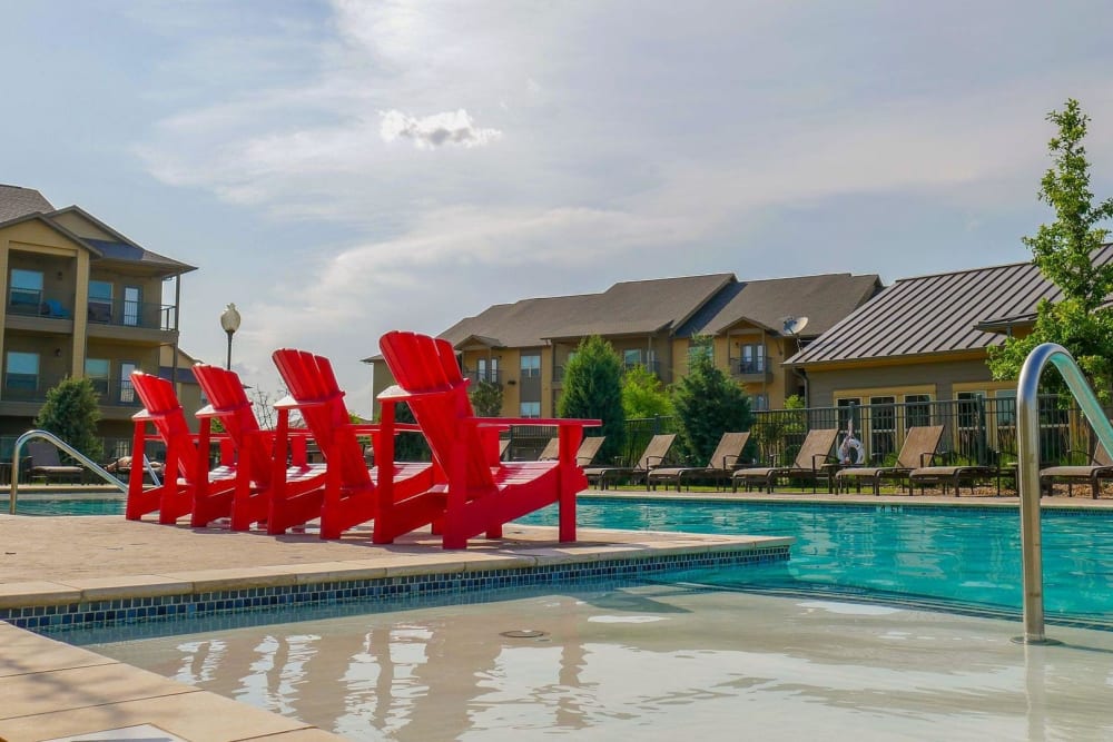 Swimming pool with sundeck and poolside Adirondack chairs at Anatole on MacArthur in Oklahoma City, Oklahoma