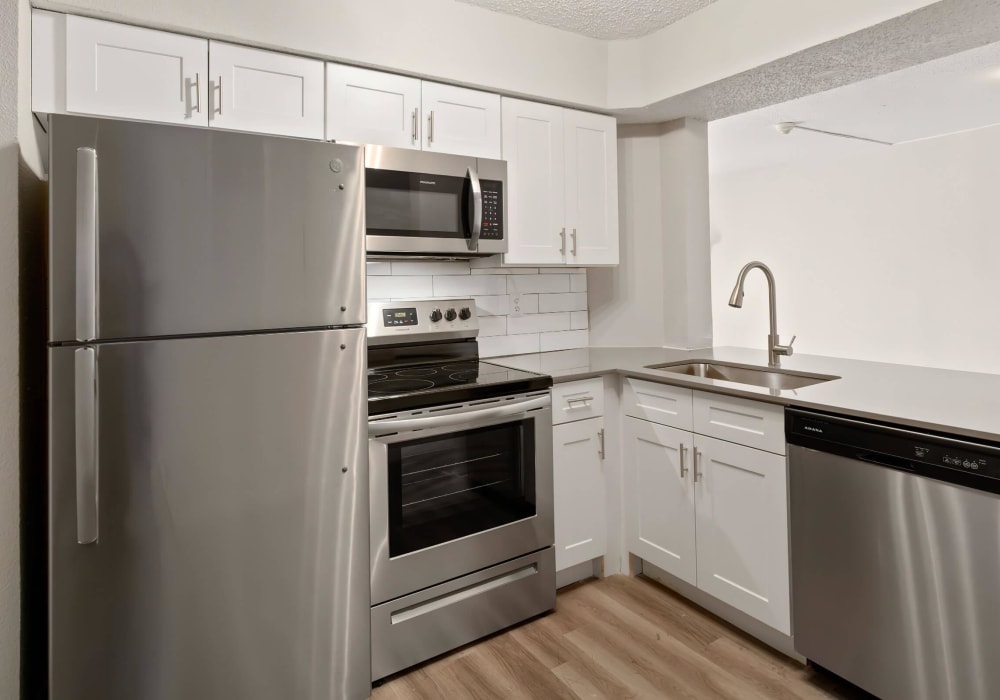 Kitchen with shiny stainless-steel appliances at Tides at Meadowbrook in Fort Worth, Texas