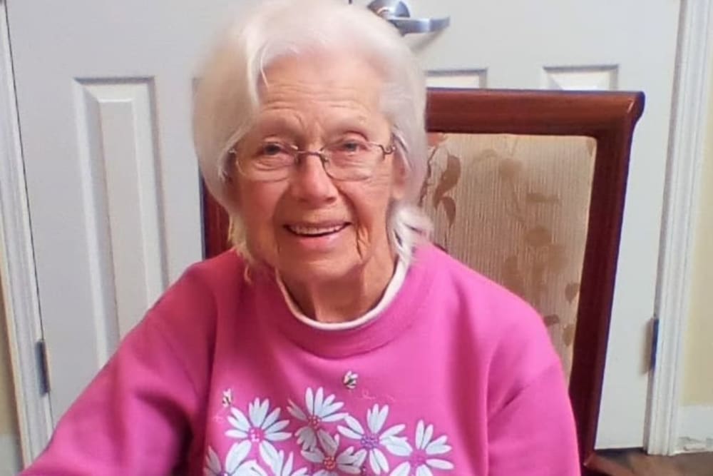 A smiling resident at Evergreen Memory Care in Eugene, Oregon.