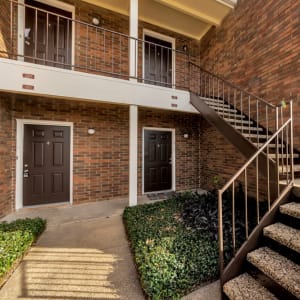 Brick exterior and apartment entrances at Summit Point Apartments in Mesquite, Texas