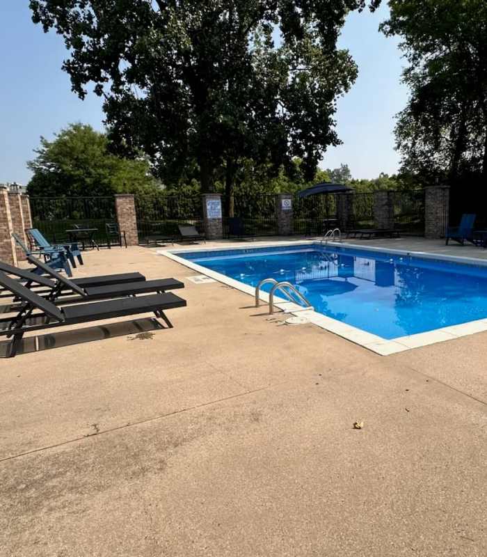 Swimming pool with pool loungers at Spring Lake Apartments in Granger, Indiana