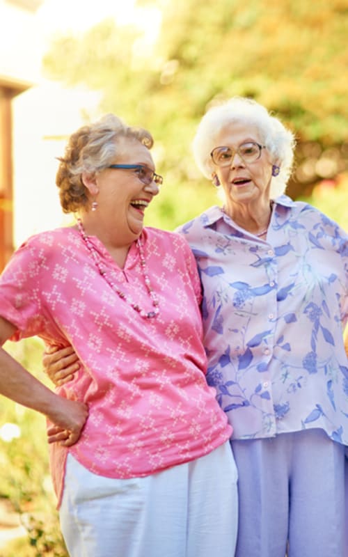 Resident couple walking outside at Regency Woodland in Salem, Oregon