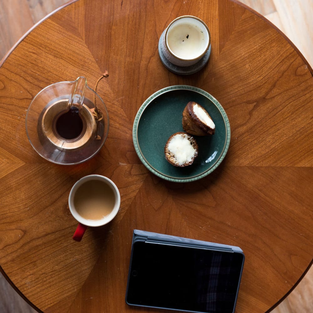 Tablet device and morning coffee and snacks on a café table near Oaks Hiawatha Station in Minneapolis, Minnesota