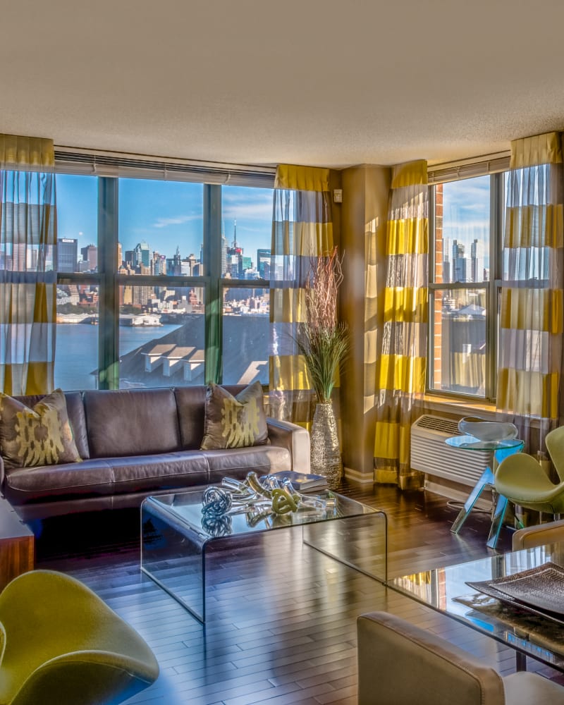 Beautiful living room with huge windows at Riverbend at Port Imperial in West New York, New Jersey