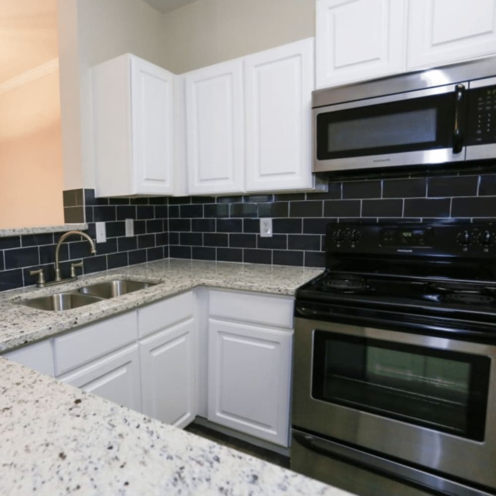 Kitchen with appliances and cabinets at Dominion Park in San Antonio, Texas