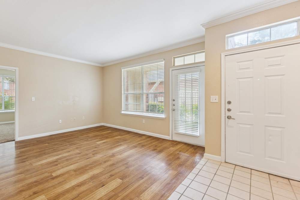 Spacious living room with windows at Brazoswood Apartments in Clute, Texas