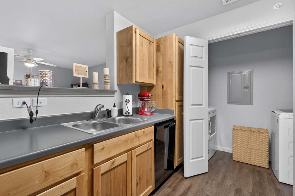 Modern kitchen with stylish wood cabinetry and sleek countertops at Lakewood Crossing in Granbury, Texas.