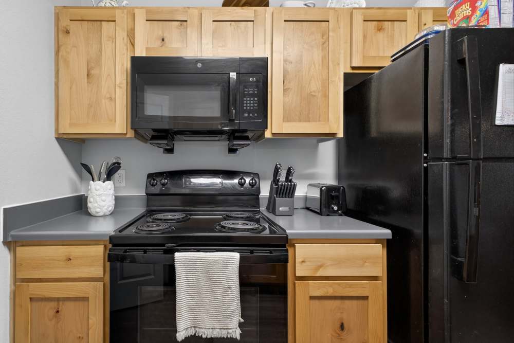 Charming kitchen with modern appliances and sleek cabinetry at Lakewood Crossing in Granbury, Texas.