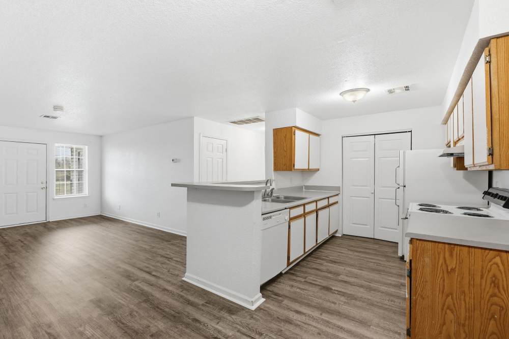 Kitchen with wooden flooring at Parkford Apartments in Iola, Kansas.