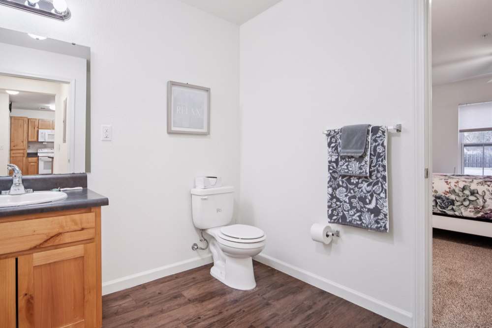 Modern bathroom with wooden cabinetry and stylish towels at Villas At Meadow Springs in Ankeny, Iowa