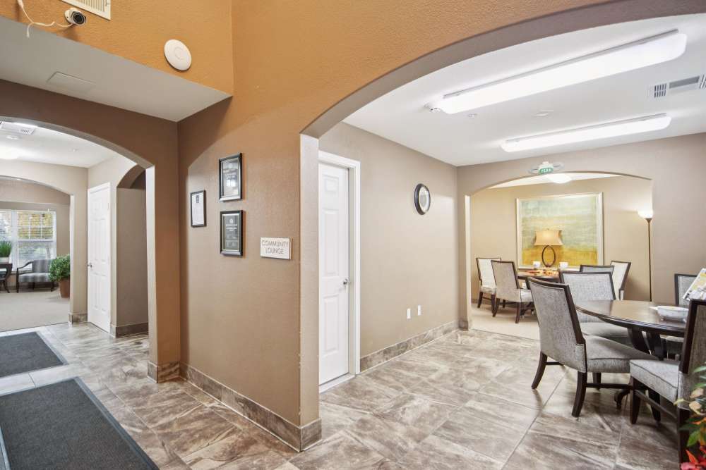 Welcoming community lounge with stylish seating and natural light at Villas At Meadow Springs in Ankeny, Iowa