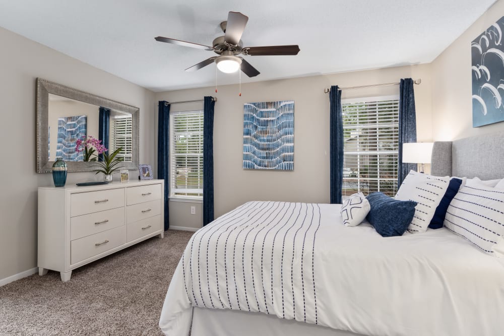 Plush carpet in an apartment bedroom with a door to the patio at Lenox Gates in Mobile, Alabama