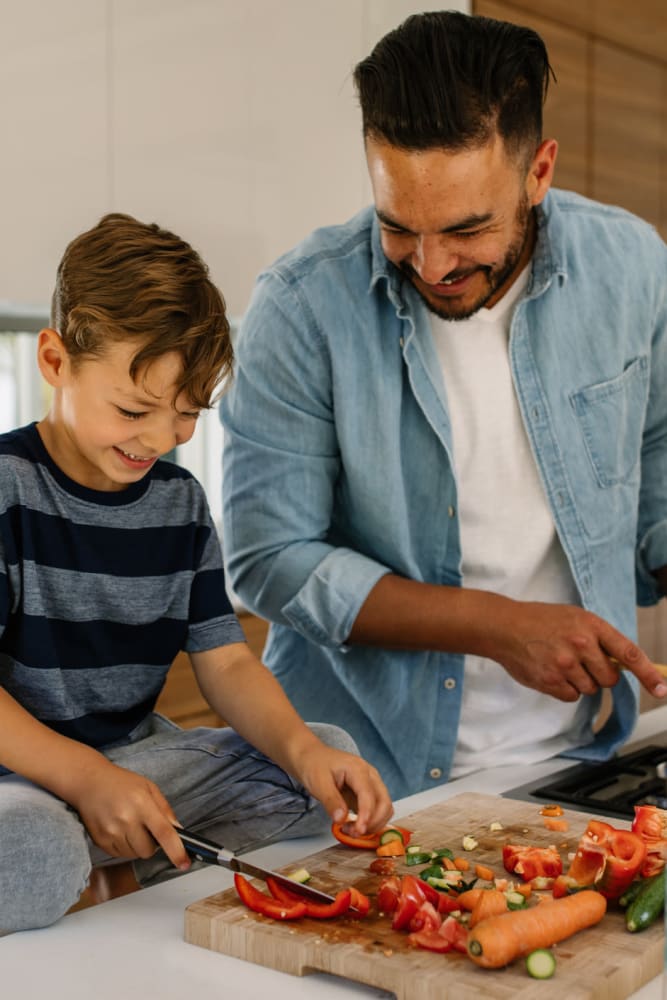 Resident cooking with his son at Lakewood Park Apartments in Lexington, Kentucky