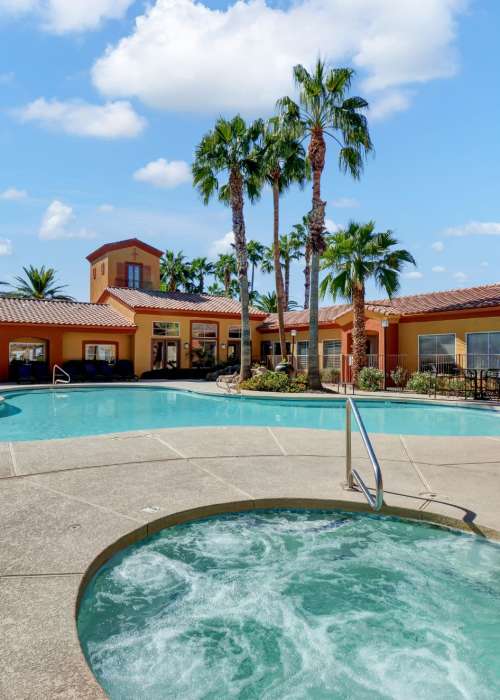 Resident relaxing near the pool at La Serena at Toscana in Phoenix, Arizona