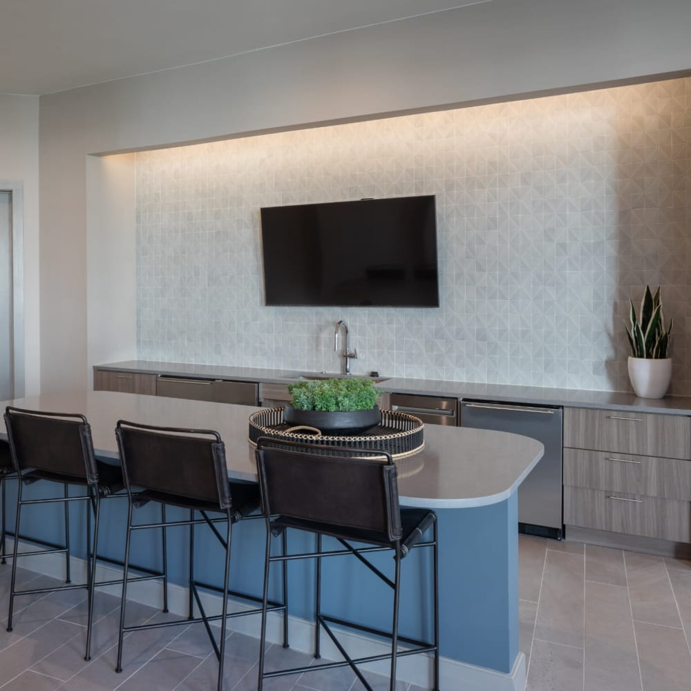 Resident bar with seating and large television at Bellrock La Frontera in Austin, Texas