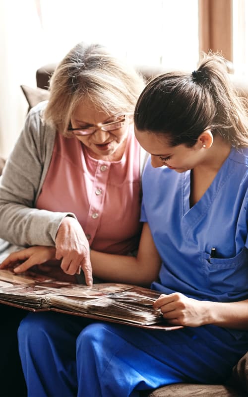 Resident looking at a photo at Sun Terrace Prosser in Prosser, Washington