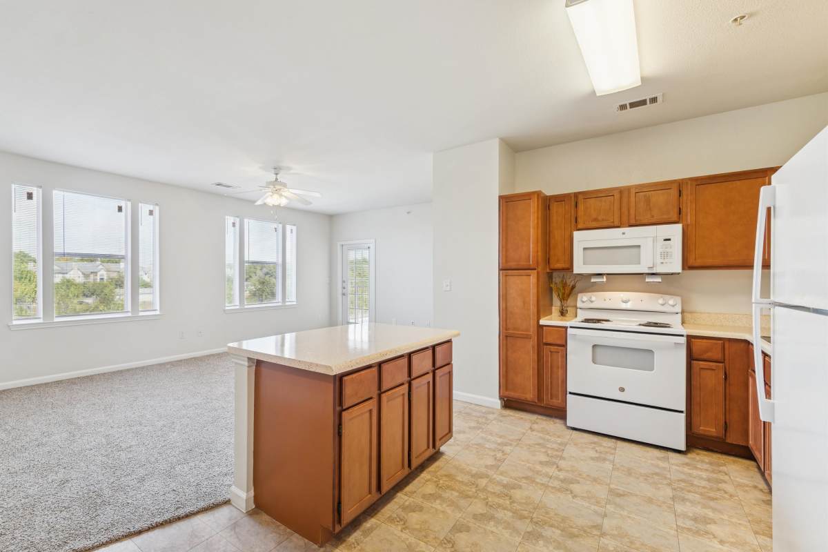 A view of a kitchen with a kitchen island at Costa Vizcaya in Houston, Texas