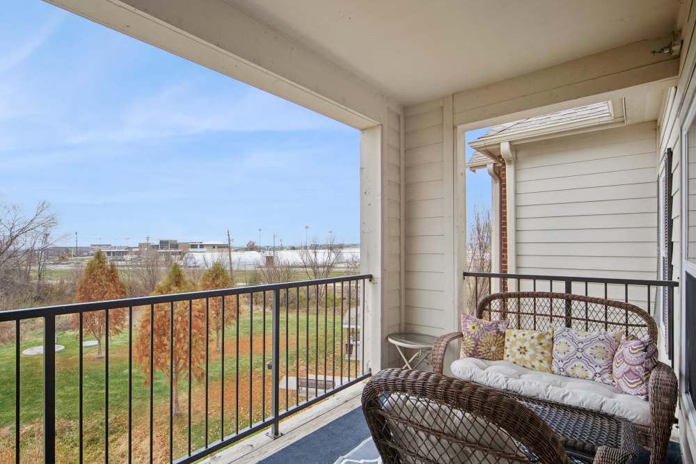 Cozy balcony with scenic views of lush greenery at Villas At Meadow Springs in Ankeny, Iowa