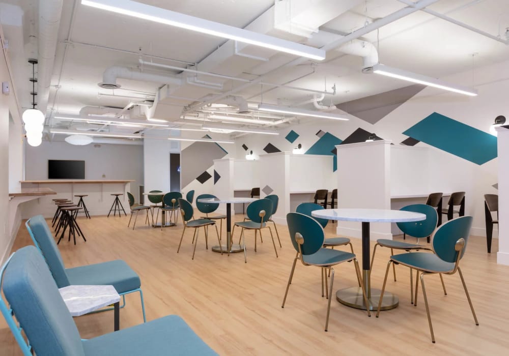 Spacious resident clubroom with ample tables and seating for work or study at K Street Flats in Berkeley, California