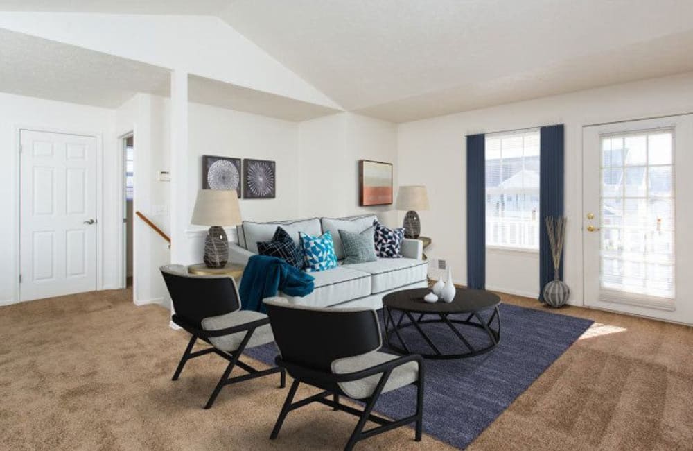 Spacious living area with plush carpeting at Westview Commons Apartments in Rochester, New York