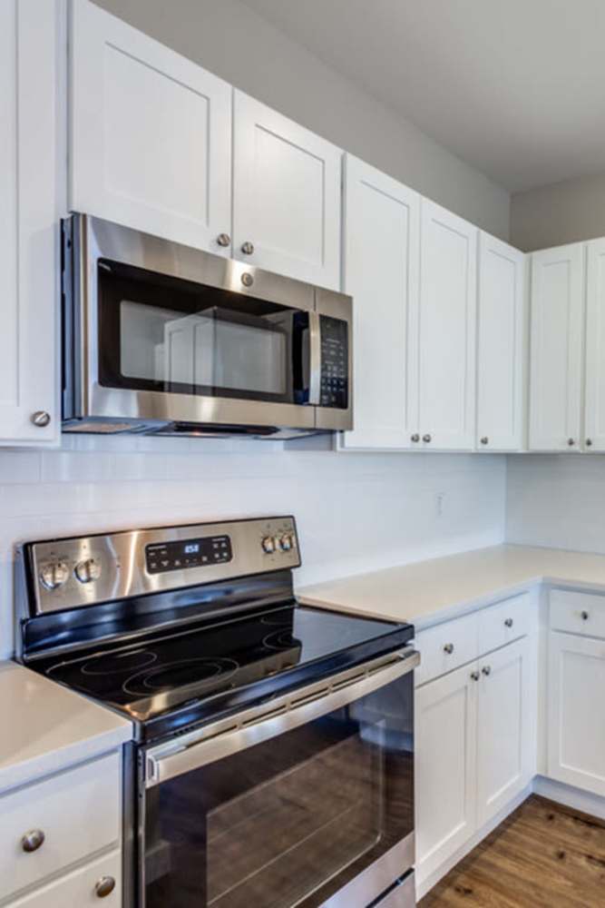 Black range in the apartment kitchen at The Trail Lakes in Fort Worth, Texas