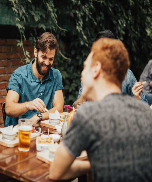 Two woman laughing at a table near 2202 Luann Place Apartments in Madison, Wisconsin
