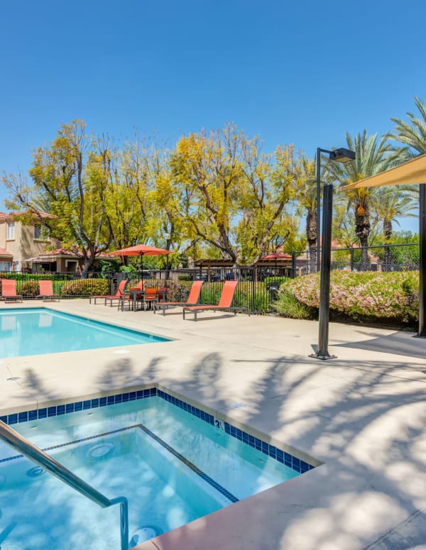 Hot Tub, pool, sun shade, and lounge area at Tuscany Village Apartments in Ontario