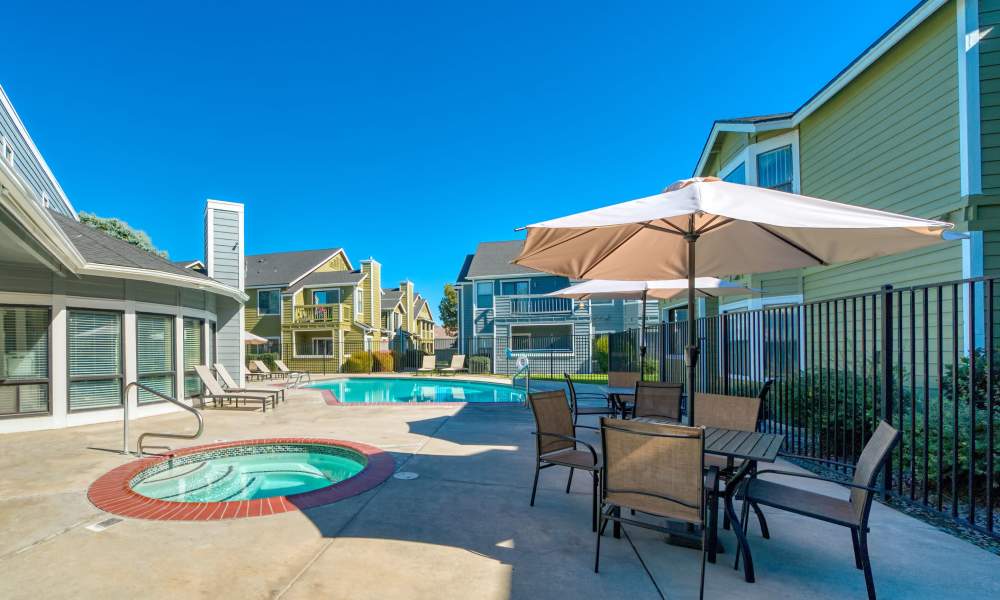 A father and his two children are having fun flying a kite in a park nearby Bristle Pointe Apartments in Reno, Nevada