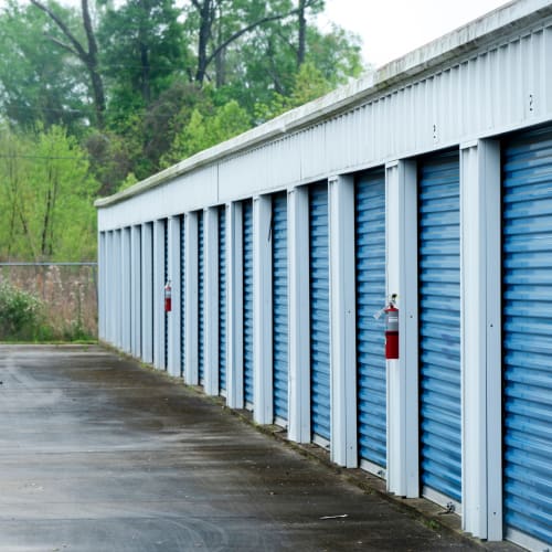 Row of storage units with blue doors at Red Dot Storage in Baker, Louisiana