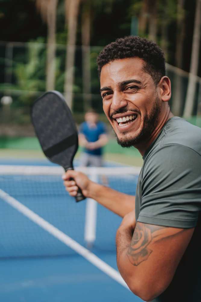 Resident playing pickle ball at Romero Apartments in Pensacola, Florida