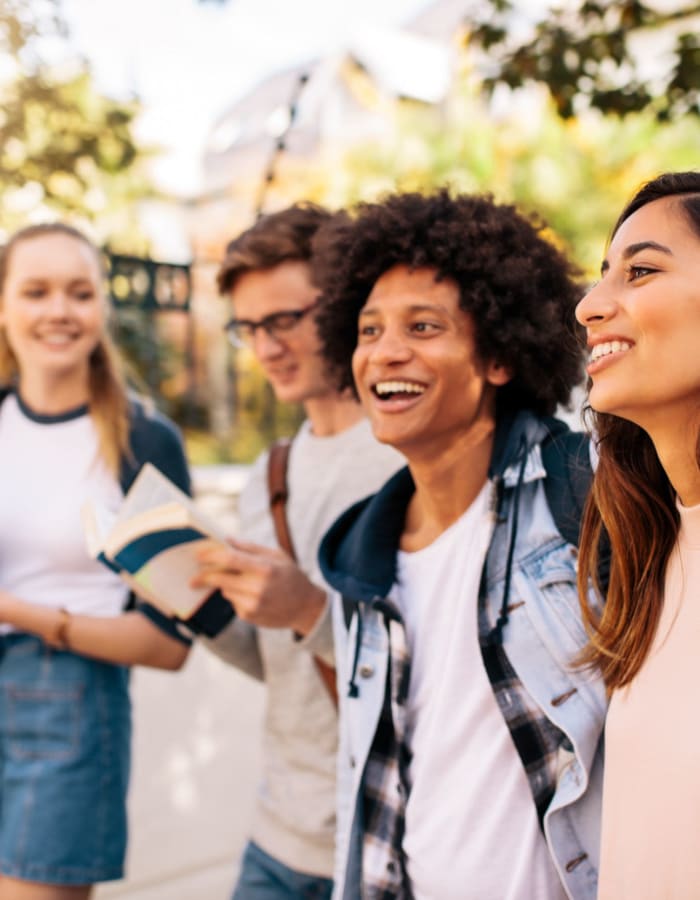 Student friends walk together near University Courtyard in Denton, Texas