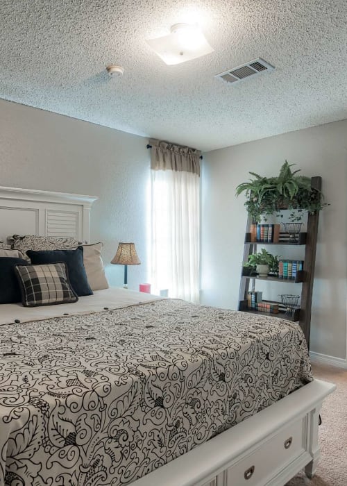 Resident bedroom with ample natural light at St. Germaine in Harvey, Louisiana