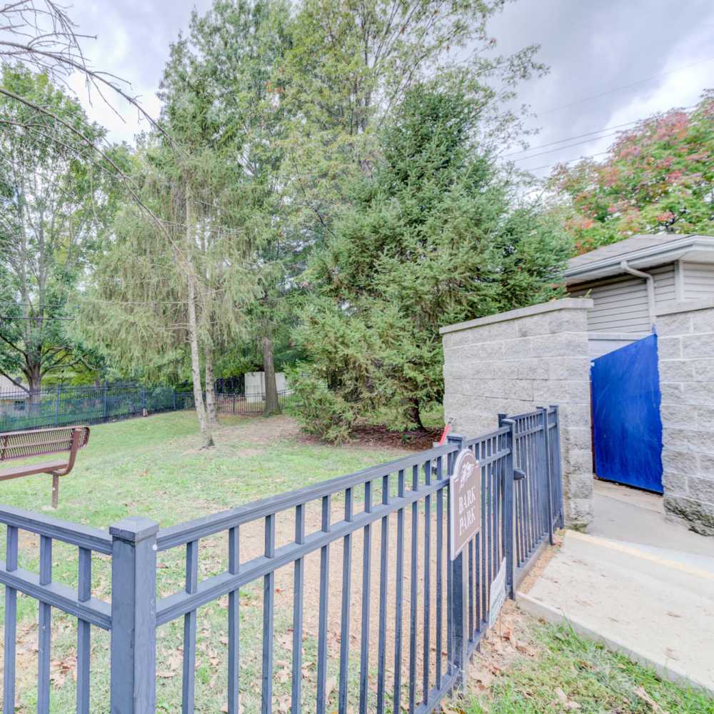Charming park area featuring lush landscaping and a welcoming bench at Boulder Springs in Maryland Heights, Missouri.