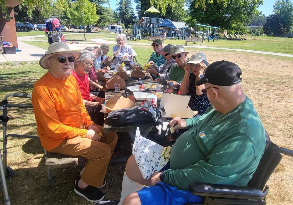 Residents having fun outdoors near Merrill Gardens at The University in Seattle, Washington