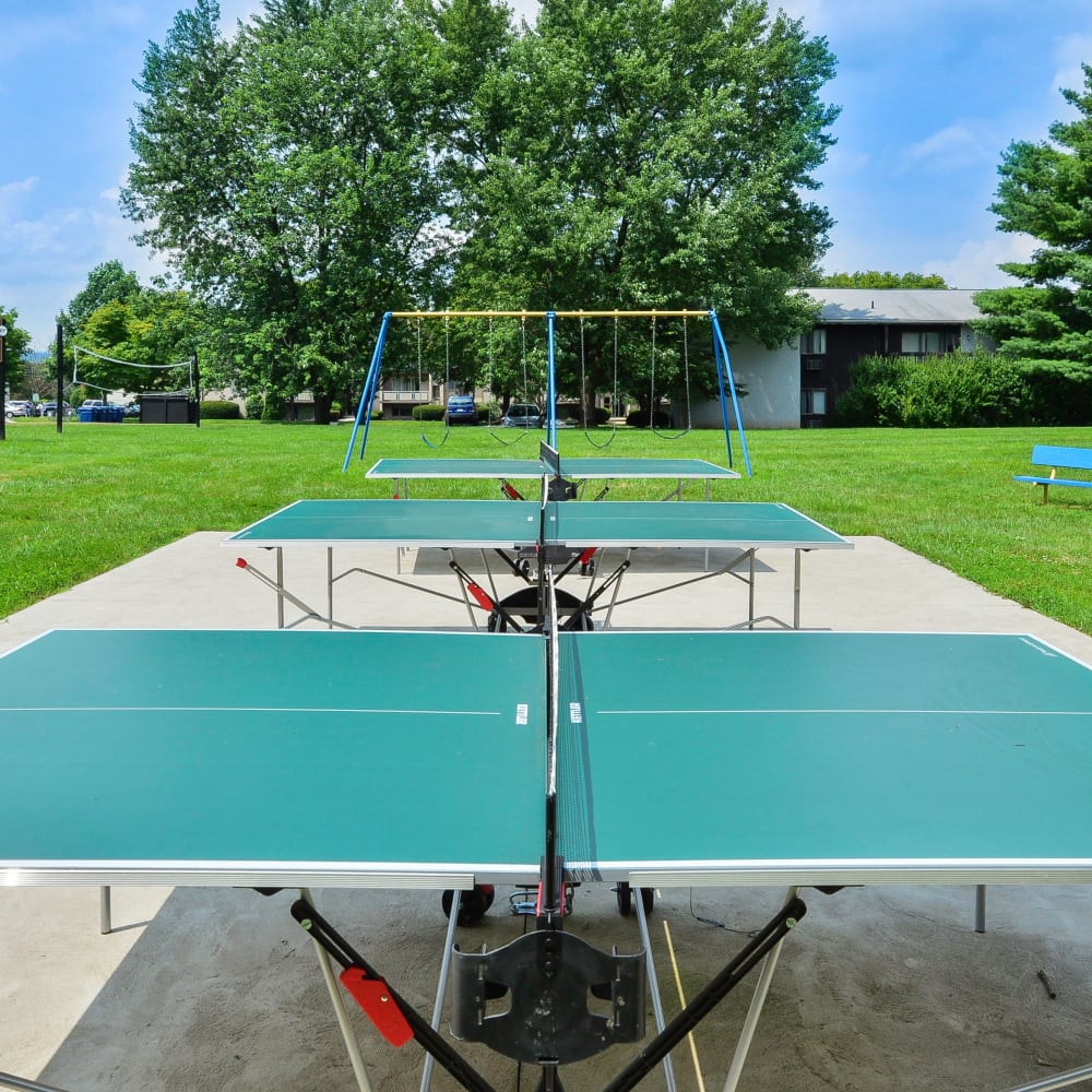 Outdoor ping pong tables and swing set at Briarwood Apartments & Townhomes in State College, Pennsylvania