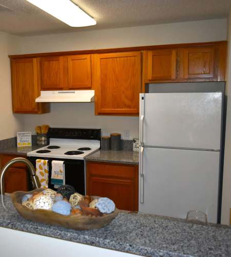 Modern kitchen with wooden cabinets at Riverfront in Mount Holly, North Carolina