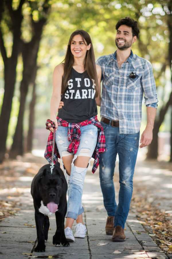 Residents walking their dog at The Abbey at Grande Oaks in San Antonio, Texas