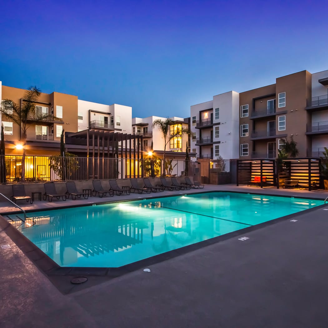 One of the swimming pools lit up at twilight at IMT Sherman Circle in Van Nuys, California