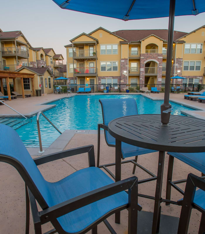 Deck seating with pool in back at Mission Point Apartments in Moore, Oklahoma