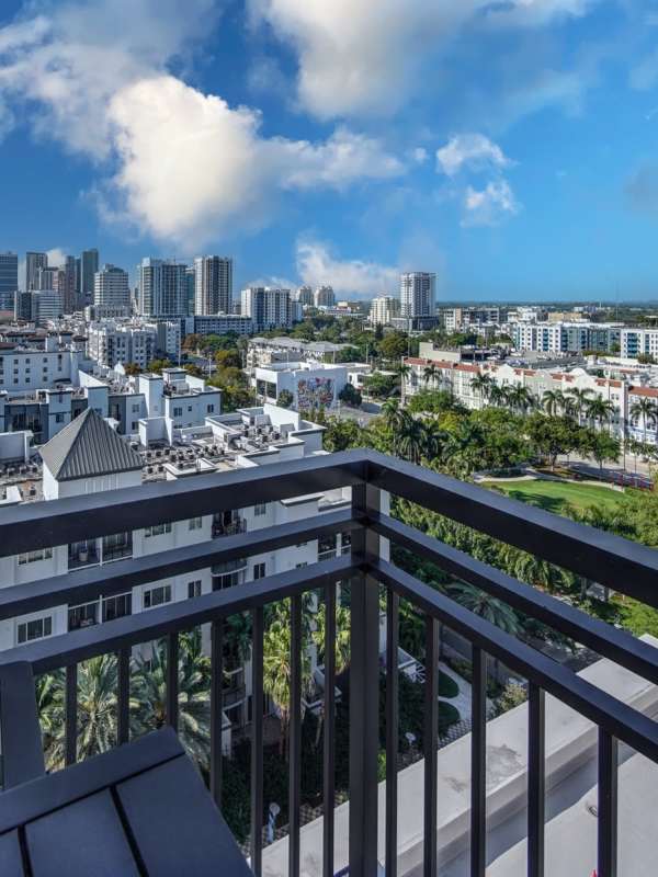 A high-rise balcony overlooking a city skyline on the partly cloudy day at EON Squared in Fort Lauderdale, Florida