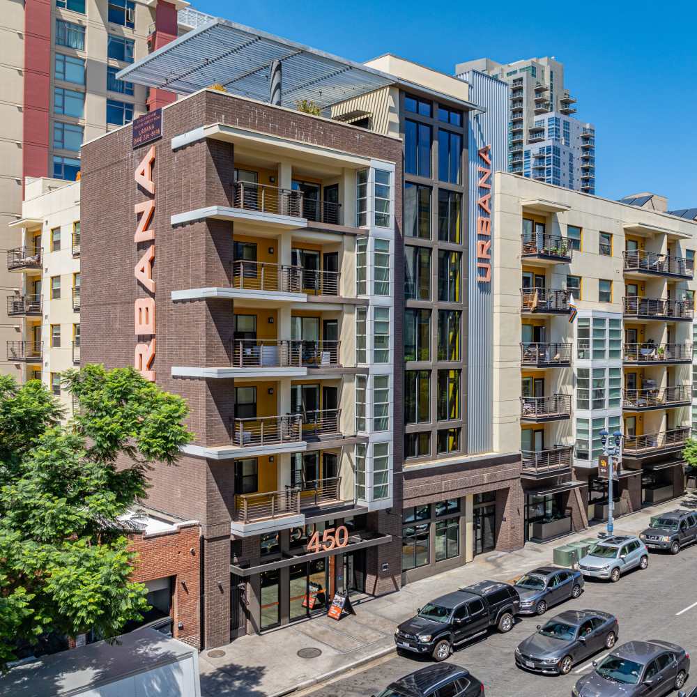 Modern apartment exterior with balconies on a city street at Urbana Rental Flats in San Diego, California