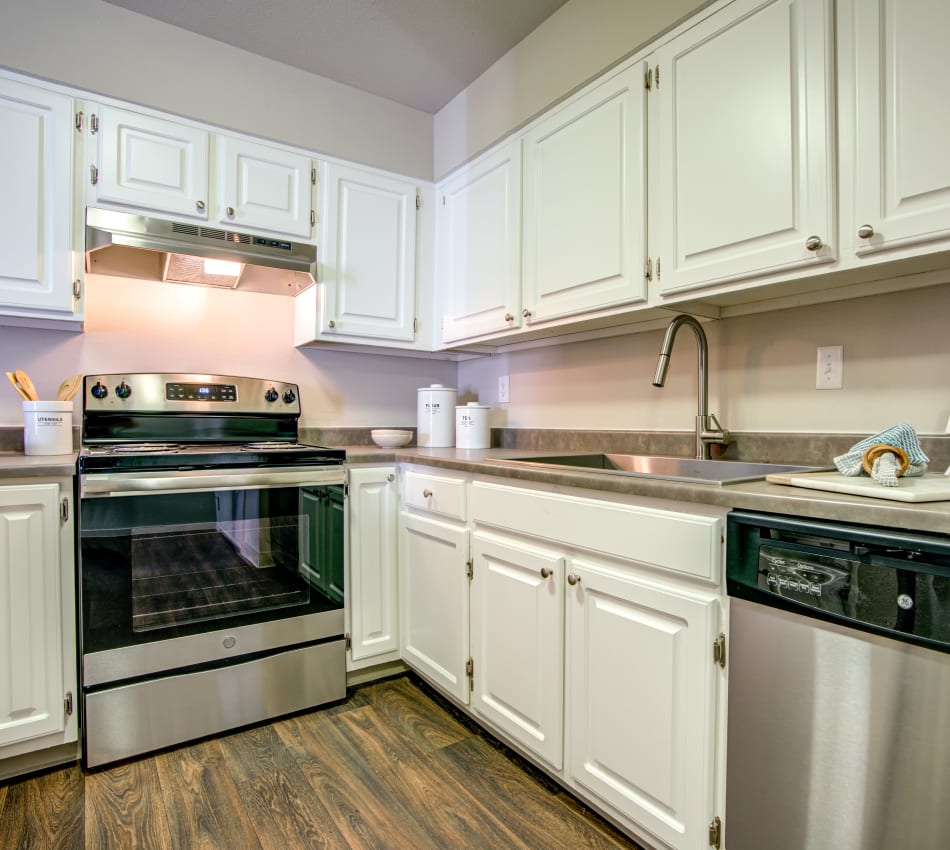 Modern kitchen with granite-style countertops in a model home at Terra Martinez in Martinez, California